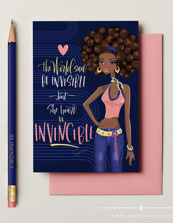 A dark blue greeting card featuring an African American illustrated woman and empowering text, accompanied by a pink envelope, stamps, and a blue pencil. Transcribed Text: The World said BE INVISIBLE but she heard BE INVINCIBLE
